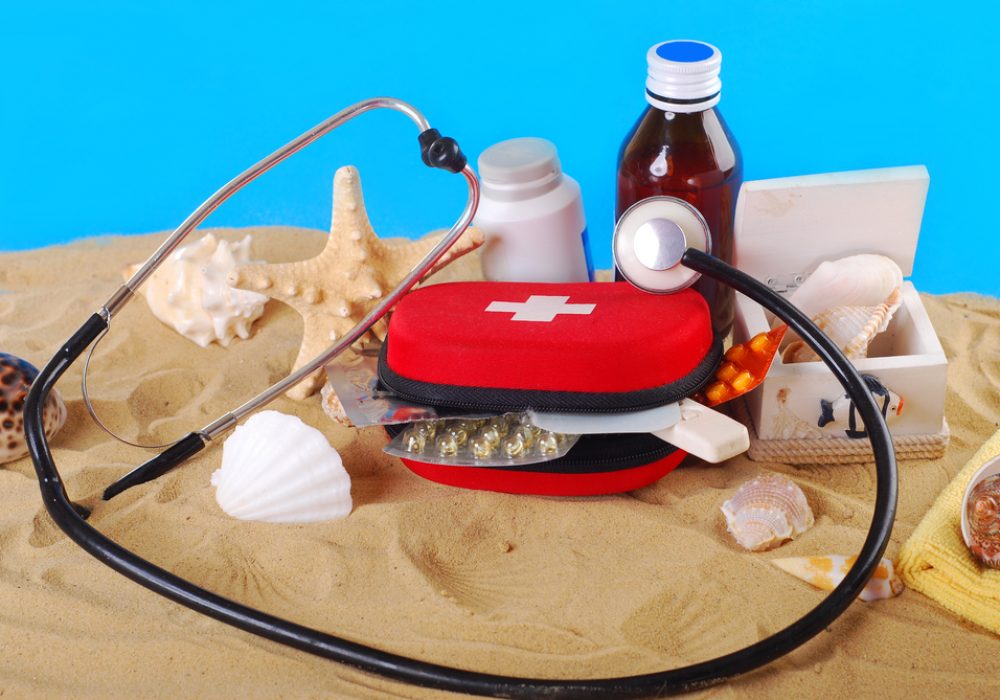 First,Aid,Box,With,Medicines,thermometer,And,Stethoscope,On,The,Beach